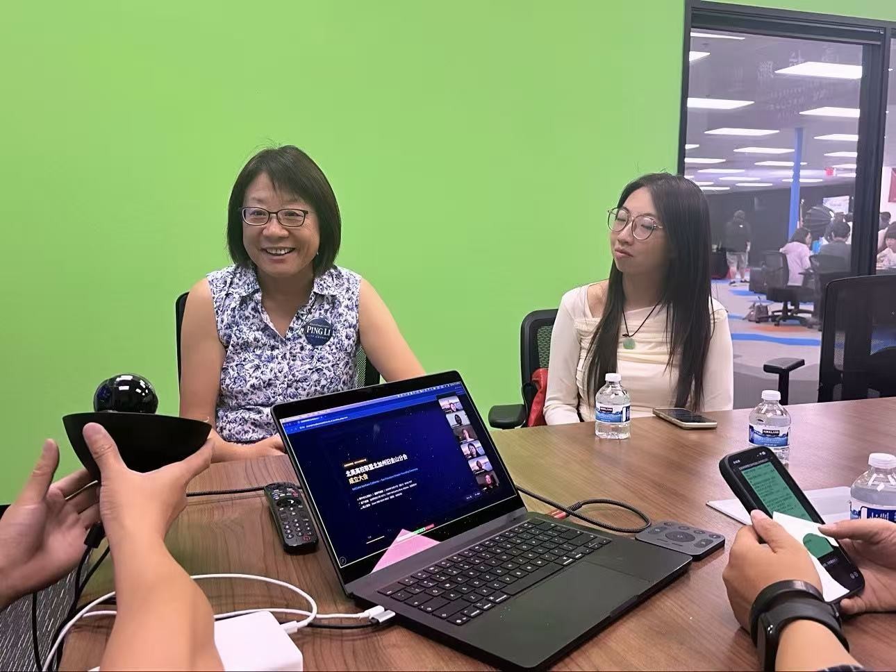 Figure: Ping Li (left) interacting with attendees at the ceremony